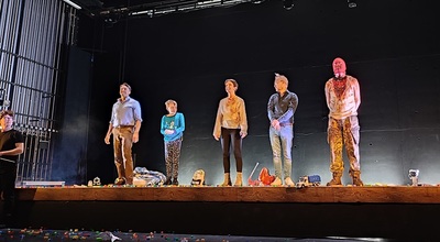 Lyric Theatre stage curtain call showing 3 singers, Sarah in the centre with young actor son on her left and composer Conor Mitchell on her right